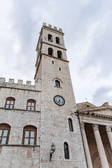 View from below of the square tower of a church in Assisi, Umbria Italy