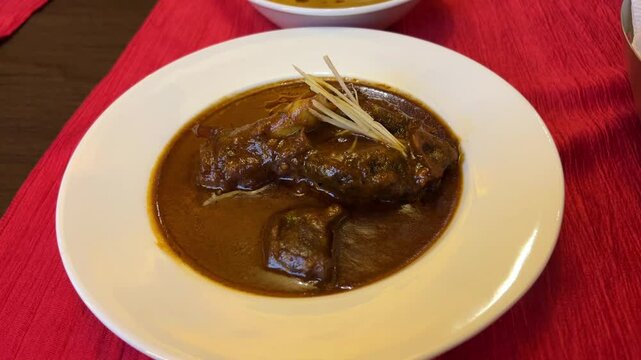 Closeup footage of mutton Roganjosh served in a Bengali restaurant.