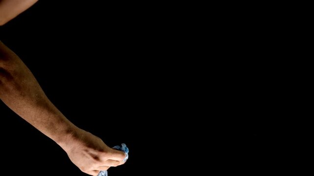 A light blue balloon is popped by a pair of scissors held in a white hand, creating a sharp, dramatic moment. The background footage enhances the visual, bringing focus to the balloon's sudden burst.