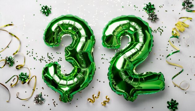 Green balloon number 32 for thirty-second birthday or anniversary party. White background with confetti