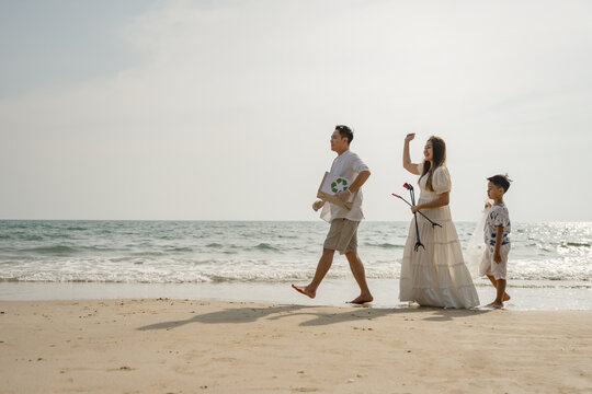 Asian family conservation recycle beach together. Father Protect environmental.