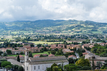 Fototapeta premium A city Gubbio Italy Umbria with many buildings and a large hill in the background