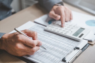 Accountant used a calculator financial analysis managing payroll tax accounting budget accounts.