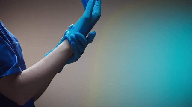Close-up of a doctor putting on medical protective gloves