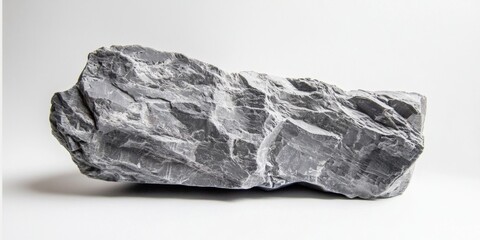 Fototapeta premium A smooth gray rock set against a bright white background.