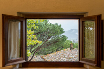 A window with a view of a tree and mountains in Italy Umbria © vip-photoworld