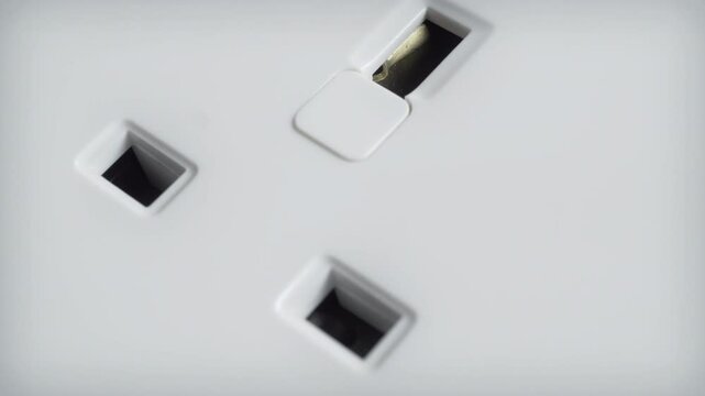 UK white electrical wall socket close up stock footage