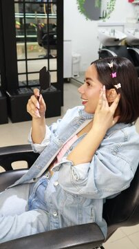 Latina girl happily wearing makeup