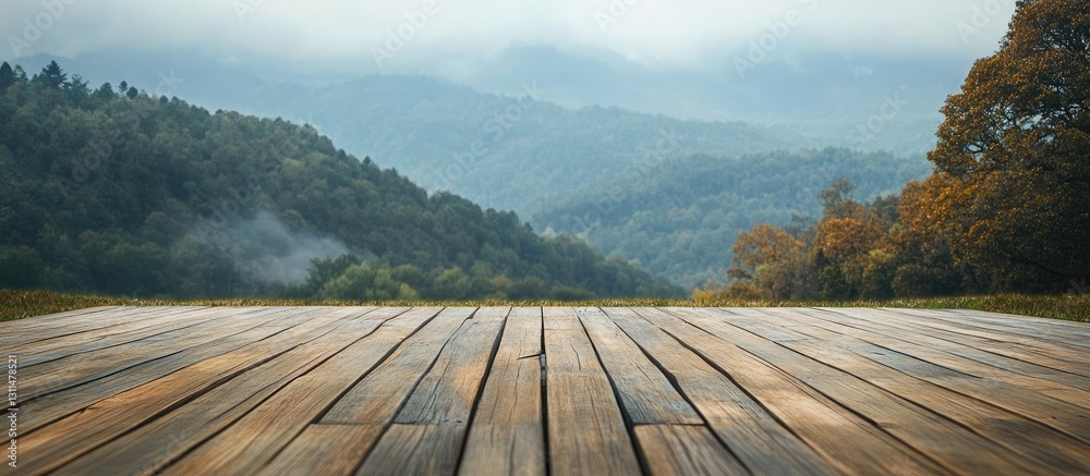 Poster wooden deck table in foreground with expansive hillside backdrop featuring green trees and misty mou
