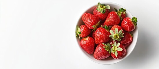 Fresh red strawberries in a white bowl positioned centrally against a white background, showcasing vibrant green leafy tops.