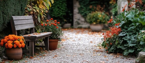 Obraz premium Autumn garden scene featuring a wooden bench surrounded by vibrant orange and red flowers, gravel pathway, and lush green foliage in soft light