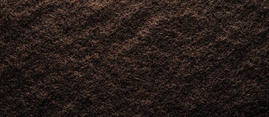 Dark brown felt texture with subtle highlights in a high-resolution background, showcasing deep earthy tones and a soft, plush appearance.