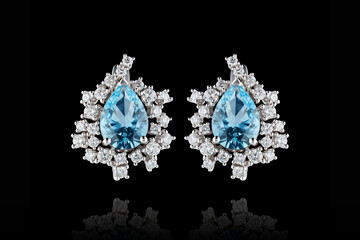 earrings silver, gold with stone aquamarine diamonds on black background