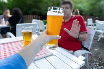 Reject a glass of beer, woman refusing alcohol, stop drinking, sobriety concept, saying no to beer...