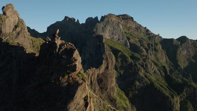 Flying along rugged ridge revealing Pico Ruivo, Madeira, Aerial Drone