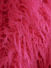 faux fur with long pile pink color, textured background