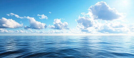 Obraz premium Serene ocean view under a bright blue sky with fluffy white clouds reflecting on smooth water surface, capturing summer tranquility and beauty.