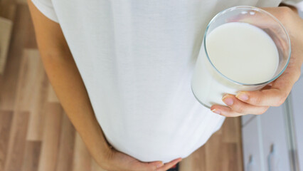Pregnant woman drinking milk, taking care of her health and her baby's
