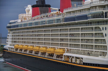 Modern family cruiseship cruise ship liner Dream or Fantasy in port of Orlando, Port Canaveral Florida USA during Summer Caribbean cruising at terminal waiting for sail away