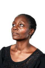 Obraz premium Woman with thoughtful expression looking up isolated on white background, reflecting deep thoughts and emotions, portrait of a serene African American female.