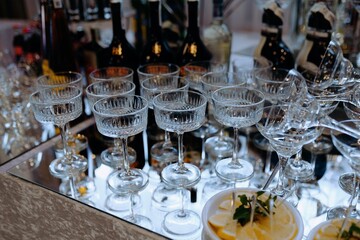 Elegant Cocktail Setup with Crystal Glasses and Bottles in a Chic Ambiance