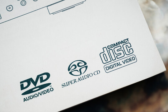 Paris, France - Mar 31, 2023: A close-up of Super Audio CD, DVD Audio Video, and Compact Disc Digital Video logos printed on a white product packaging box, emphasizing media format compatibility