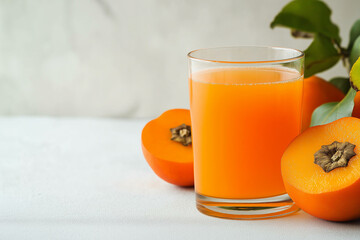 Persimmon juice in a glass , against a white background. A healthy drink concept