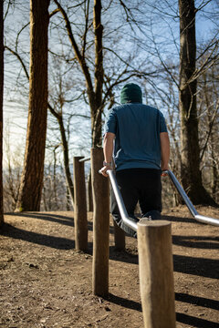 man doing exercise in parallel bar