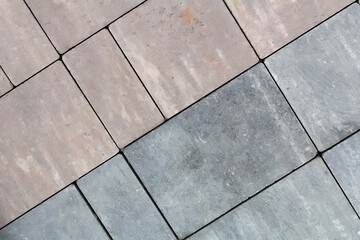 Multicolored paving slabs for road paving by mosaic on shop window