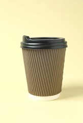 Paper cup with plastic lid on light background. Coffee to go
