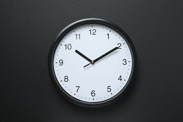 Big beautiful stylish clock on black background