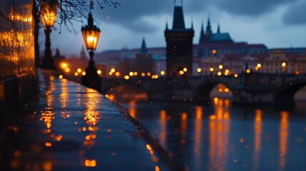 Obraz premium The Charles Bridge is illuminated by the city lights on a rainy evening.