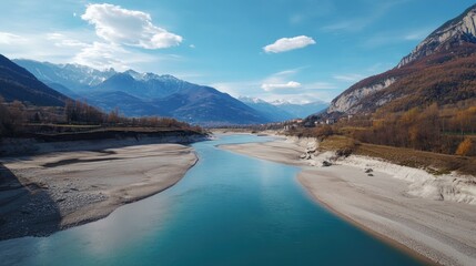 Naklejka premium Stunning view of a mountain river, surrounded by lush trees and majestic peaks in the distance. Ideal for outdoor enthusiasts and nature lovers.