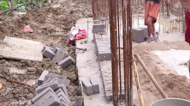 Construction workers using reinforced tmt steel bar with ease at the construction site, Reinforced bar (rebar). TMT steel rods tied together forming the core of concrete