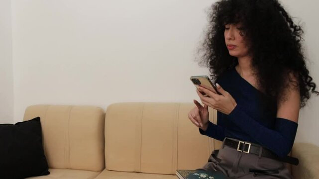 Video of a Latina woman making a call and taking notes on a notepad