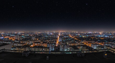 Obraz premium Stunning nighttime urban skyline with city lights and starry sky