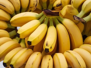 A vibrant cluster of ripe yellow bananas arranged in a circular pattern.