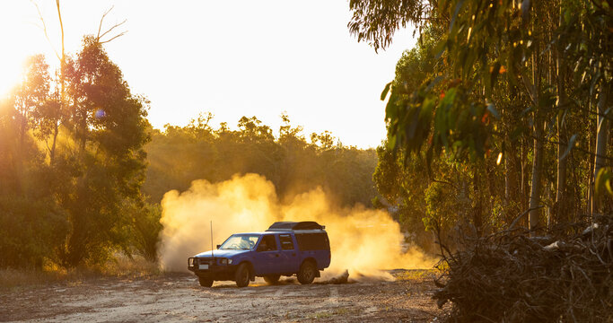 ute doing brodies on dirt track with dust billowing behind