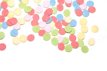 Close up of sugar paper confetti circle spots and colour dots on white background