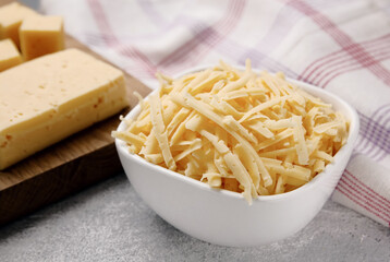 Heap of grated delicious cheese. Concept: Italian cuisine, cheese, restaurant, and food.