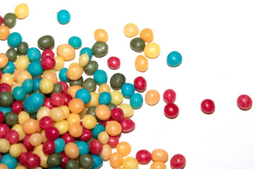 Close up of round ball sugar ice cream cake decorations on a white background