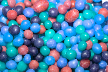 Close up of round ball sugar ice cream cake decorations on a white background
