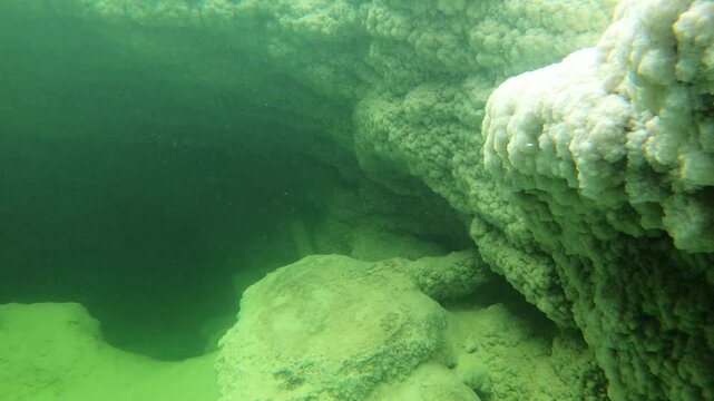 Underwater view of huge rocks made of salt on lake in the Danakil depression and desert in North Ethiopia
