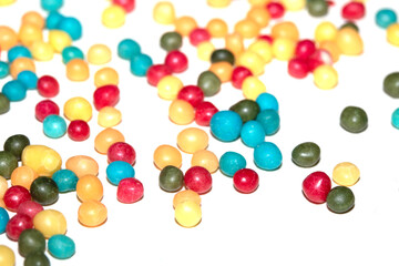 Close up of round ball sugar ice cream cake decorations on a white background