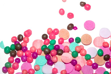Close up of sprinkles sugar balls and chocolate cake ice cream decoration strands on white background
