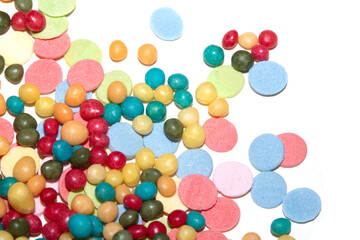Close up of sprinkles sugar balls and chocolate cake ice cream decoration strands on white background
