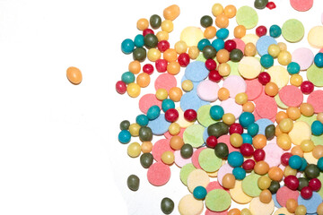 Close up of sprinkles sugar balls and chocolate cake ice cream decoration strands on white background
