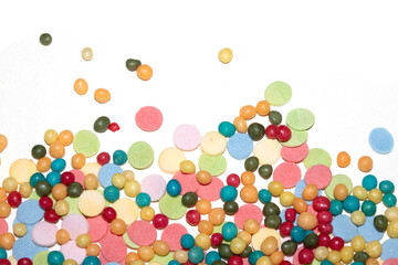 Close up of sprinkles sugar balls and chocolate cake ice cream decoration strands on white background
