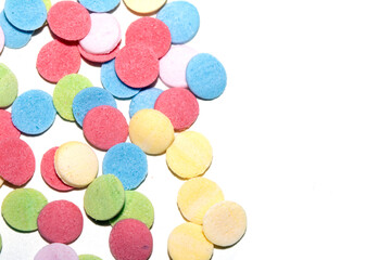 Close up of sugar paper confetti circle spots and colour dots on white background