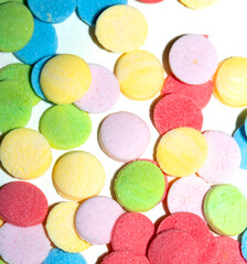 Close up of sugar paper confetti circle spots and colour dots on white background